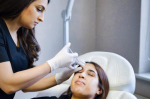 image of facial aesthetic clinician at work